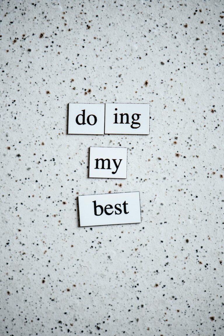 Black and white inspirational quote 'doing my best' on a speckled surface.